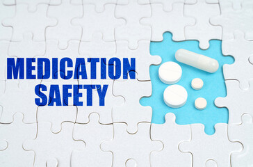 On the puzzles there is an inscription - Medication Safety, on a blue background pills.
