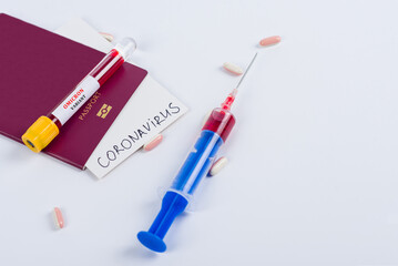 Passport and test tube with a positive blood test for Omicron. Pills and syringe with blood for coronavirus analysis (COVID-19)