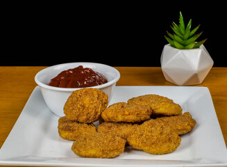 plate of chicken nuggets with barbecue