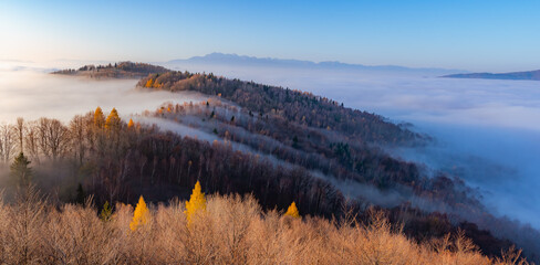 Misty autumn mountains landscape in the morning, Poland, Beskidy mountains and Tatra mountains in the background