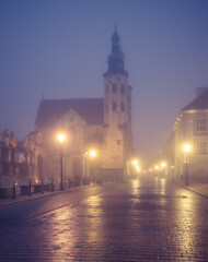 Fototapeta na wymiar Krakow old town, St Andrew church on Grodzka street in the foggy night