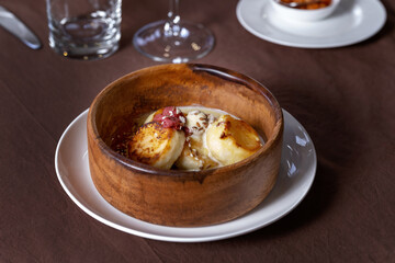 Cottage cheese pancakes, syrniki, with strawberry jam close up.