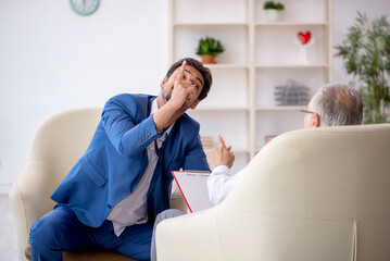 Fototapeta premium Young businessman employee visiting psychologist