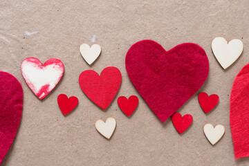 wood and felt hearts (of various sizes) on plain brown textured paper