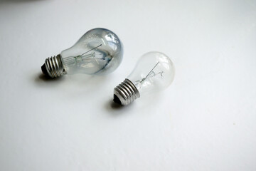 burned out and new light bulb on a white background, close-up