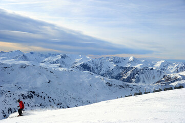 Naklejka na ściany i meble Skiing people on the slopes of ski resort in winter 