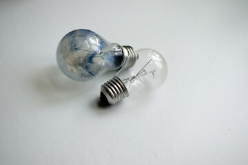 burned out and new light bulb on a white background, close-up