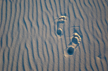 Foot steps on the sand