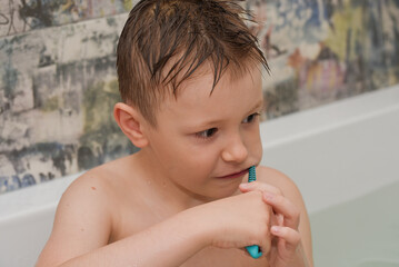 boy in the bathroom brushes his teeth myself