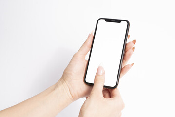 Mobile phone with blank white screen held in two hands on white background