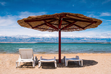 View of the beautiful blue sky and straw beach umbrellas