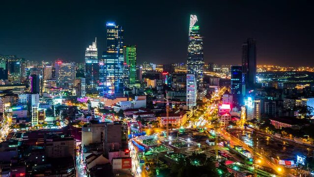 Zoom out time lapse view of Ho Chi Minh City, aka Saigon, Vietnam, showing modern skyscrapers and rush hour traffic in the financial district.