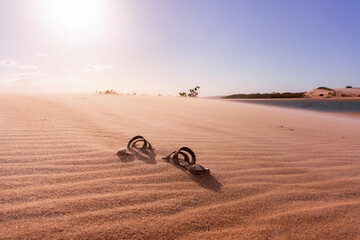 Lost sandals in sand dunes