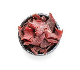 Bowl with spicy beef jerky on white background