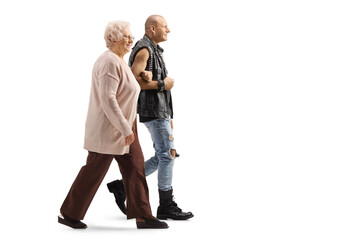 Full length profile shot of a punk and a senior lady walking