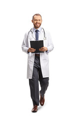 Full length portrait of a smiling young male doctor holding a clipboard and walking towards camera