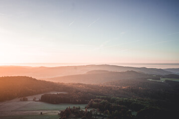 Natural Foggy European Landscape during morning Sunrise with Hills and valleys