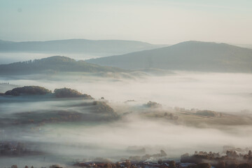 Natural Foggy European Landscape during morning Sunrise with Hills and valleys
