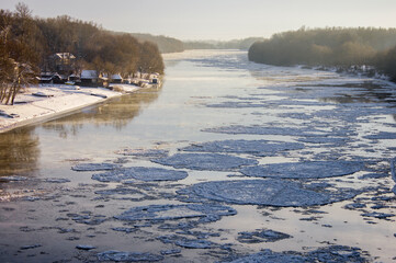ice floes move along the river in winter in frost