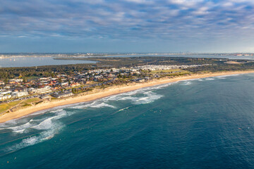 Aerial drone view of Cronulla Beach in the Sutherland Shire, South Sydney during summer in the early morning  