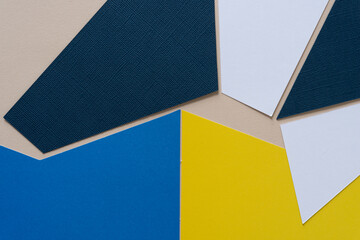 background with paper shapes in blue, white, and yellow 