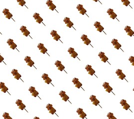Seamless abstract pattern. Grilled pork. Brown skewers. Bamboo skewers.  white background  Use for designing trousers, shirts, clothing and other fabric patterns.  in the textile industry