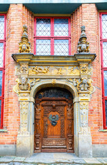 Fototapeta na wymiar Antique carved wooden door of luxury gothic mansion