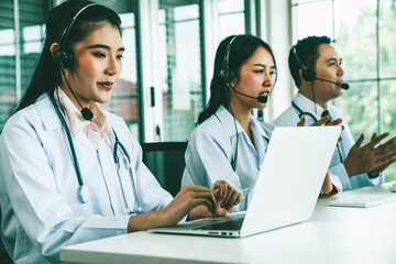 Doctor team wearing headset talking actively on video call in hospital clinic . Concept of...