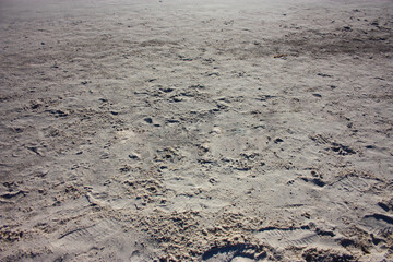 fine white sand of a beach at the warm hour of sunset