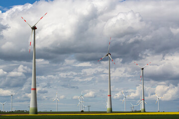 renewable energy, landscape with wind mill, wind mill park, wind mills standing in a line