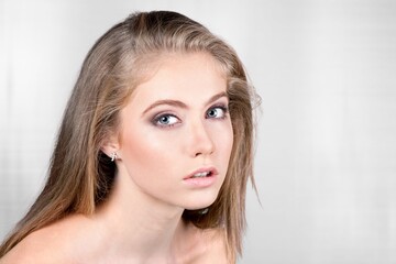 Fototapeta premium Beautiful young woman with clean perfect glowing skin, smiling