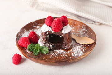 Plate with tasty lava cake fondant with mint and raspberry on white background, closeup