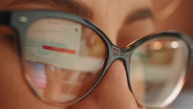 Women shopping online, reflection in glasses of the hands and credit card making e bank online payment. Ecommerce website payments concept.