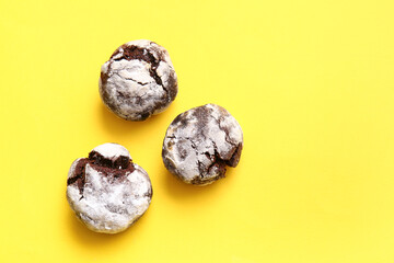 Tasty chocolate brownie cookies on yellow background