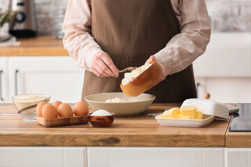 Woman preparing cottage cheese pancakes at kitchen table, closeup