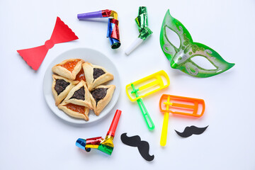 Plate with hamantaschen and decor for Purim holiday on white background