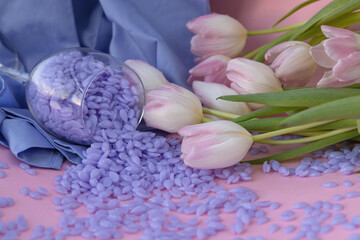 Spring depilation concept, tulips and wax. Set of depilation and beauty on blue spring removal waxing.