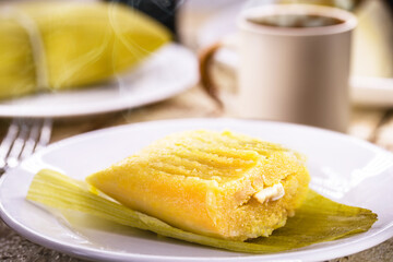 Typical Brazilian sweet pamonha made with corn and stuffed with cheese, served hot. Traditional food from Minas Gerais state