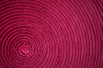 Close up of a fuchsia piece of cloth textured background with circles 