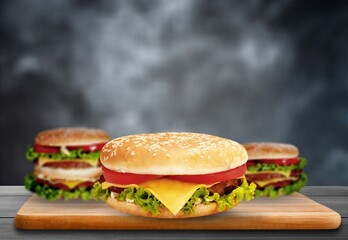 Fresh tasty burger on wooden desk