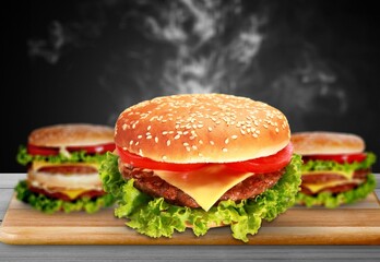 Fresh tasty burger on wooden desk
