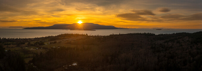 Sun Setting Behind Orcas Island, Washington. Beautiful sunset in the San Juan Islands seen with a...