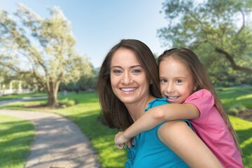 Naklejka premium Happy mother having fun with her daughter outdoor