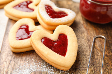 Board with tasty cookies for Valentine's Day celebration on table, closeup