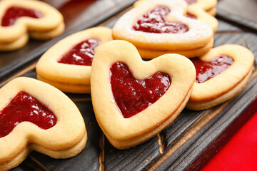 Board with tasty cookies for Valentine's Day celebration on table, closeup
