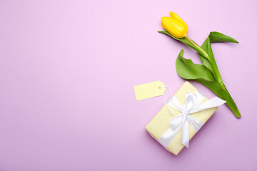 Composition with gift box, blank card and tulip for International Women's Day celebration on color background