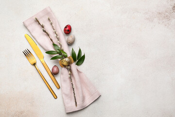Stylish cutlery for Easter celebration on light background