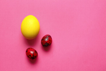 Different painted Easter eggs on color background