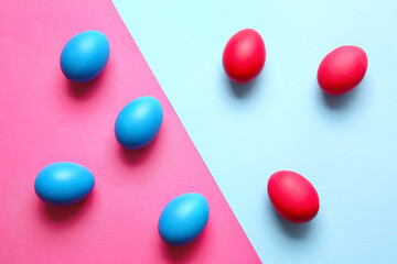 Blue and red Easter eggs on color background