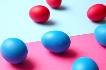 Blue and red Easter eggs on color background